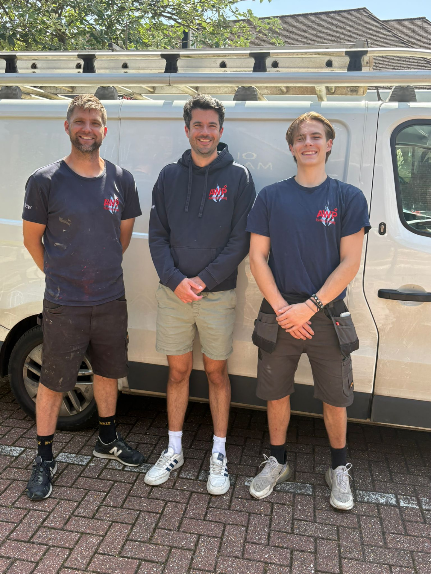 The AWP Plumbing & Heating team stood in front of the company van
